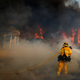A firefighter battles a wildfire at Faria State Beach in Ventura, CA on Thursday. (Image: AP)